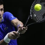 
              FILE - Serbia's Novak Djokovic returns the ball to Croatia's Marin Cilic during their Davis Cup tennis semi-final match at Madrid Arena in Madrid, Spain, Friday, Dec. 3, 2021. An Australian judge reinstated tennis star Novak Djokovic's visa Monday, Jan. 10, 2022, which was canceled last week because he is unvaccinated. (AP Photo/Bernat Armangue, File)
            