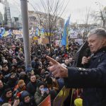
              Former Ukrainian President Petro Poroshenko, right, speaks to a crowd in front of a court building prior to a court session, in Kyiv, Ukraine, Wednesday, Jan. 19, 2022. A Kyiv court is due to rule on whether to remand Poroshenko in custody pending investigation and trial on treason charges he believes are politically motivated. (AP Photo/Efrem Lukatsky)
            