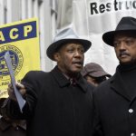 
              FILE - Dennis Hayes, left, interim president and CEO of the NAACP, and the Rev. Jesse Jackson, founder and president of the Rainbow/PUSH Coalition, wait for their turn at the podium during a rally to call for mortgage lending reform Dec. 10, 2007, in New York's Financial District. The NAACP, the nation's oldest civil rights organization, will soon celebrate its 113th birthday, which its leaderships said comes as it undergoes a restructuring to reflect a membership and leadership that is trending younger. (AP Photo/Richard Drew, File)
            