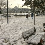
              People walk over the Golden Horn with Suleymaniye Mosque in the background at Istanbul, Tuesday, Jan. 25, 2022. Rescue crews in Istanbul and Athens on Tuesday cleared roads that had come to a standstill after a massive cold front and snowstorms hit much of Turkey and Greece, leaving countless people and vehicles in both cities stranded overnight in freezing conditions.(AP Photo/Emrah Gurel)
            