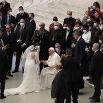
              Pope Francis newly married couple at the end of his weekly general audience in the Paul VI Hall, at the Vatican, Wednesday, Jan. 26, 2022. (AP Photo/Alessandra Tarantino)
            