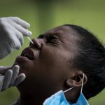 
              A person gives a nasal sample for a COVID-19 test at a test site set up at a school in Rio de Janeiro, Brazil, Friday, Jan. 7, 2022. (AP Photo/Bruna Prado)
            