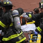 
              Emergency personnel use a manual resuscitator on a fire victim during a high rise fire on East 181 Street, Sunday, Jan. 9, 2022, in the Bronx borough of New York. (AP Photo/Lloyd Mitchell)
            