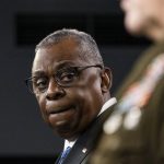 
              Secretary of Defense Lloyd Austin turns to Joint Chiefs Chairman Gen. Mark Milley as he speaks during a media briefing at the Pentagon, Friday, Jan. 28, 2022, in Washington. (AP Photo/Alex Brandon)
            