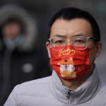 
              A man wearing a face mask printed with a cartoon tiger walks on a street during the Lunar New Year eve in Beijing, Monday, Jan. 31, 2022. The pandemic is muting Lunar New Year celebrations again this year, though people around Asia are finding ways to mark the traditional holiday despite restrictions on travel, restaurants and large gatherings. The Lunar New Year falls on Tuesday. (AP Photo/Andy Wong)
            