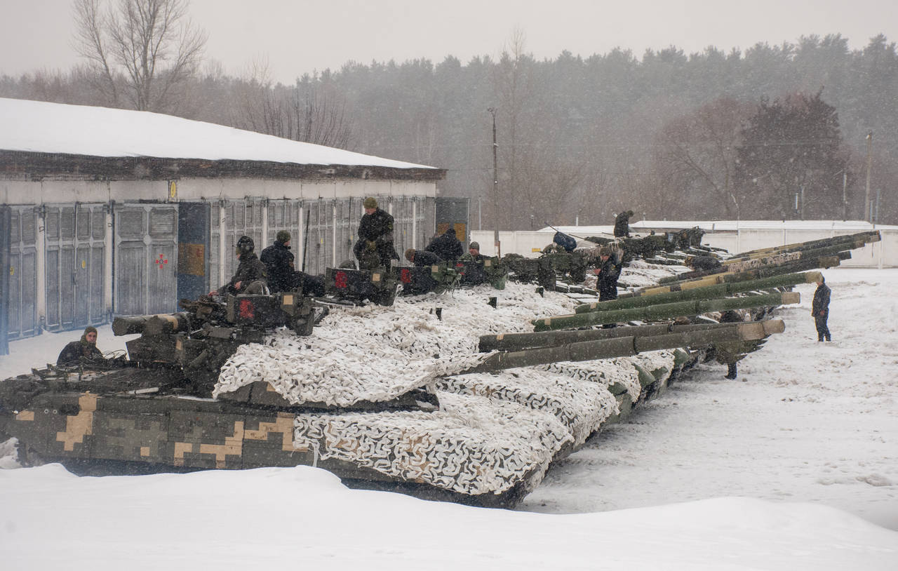 Ukrainian soldiers examine their tanks at a military unit close to Kharkiv, Ukraine, Monday, Jan. 3...