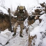 
              A Ukrainian serviceman walks to his position in a trench on the front line in the Luhansk region, eastern Ukraine, Friday, Jan. 28, 2022. High-stakes diplomacy continued on Friday in a bid to avert a war in Eastern Europe. The urgent efforts come as 100,000 Russian troops are massed near Ukraine's border and the Biden administration worries that Russian President Vladimir Putin will mount some sort of invasion within weeks. (AP Photo/Vadim Ghirda)
            