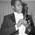 
              REMOVES REFERENCE TO THE BAHAMAS - FILE - Actor Sidney Poitier poses with his Oscar for best actor for "Lillies of the Field" at the 36th Annual Academy Awards in Santa Monica, Calif. on April 13, 1964.  Poitier, the groundbreaking actor and enduring inspiration who transformed how Black people were portrayed on screen, became the first Black actor to win an Academy Award for best lead performance and the first to be a top box-office draw, died Thursday, Jan. 6, 2022. He was 94. (AP Photo, File)
            