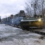 
              In this photo taken from video provided by the Russian Defense Ministry Press Service, A Russian armored vehicle drives off a railway platform after arrival in Belarus, Wednesday, Jan. 19, 2022. In a move that further beefs up forces near Ukraine, Russia has sent an unspecified number of troops from the country's far east to its ally Belarus, which shares a border with Ukraine, for major war games next month. (Russian Defense Ministry Press Service via AP)
            