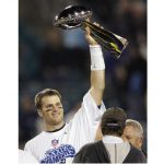 
              FILE - In this Feb. 6, 2005, file photo, New England Patriots quarterback Tom Brady raises the Vince Lombardi Trophy over coach Bill Belichick and team owner Robert Kraft, right, after they beat the Philadelphia Eagles, 24-21, in Super Bowl 39 in Jacksonville, Fla. Despite reports that he is retiring, Brady has told the Tampa Bay Buccaneers he hasn't made up his mind, two people familiar with the details told The Associated Press, Saturday, Jan. 29, 2022. (AP Photo/Julie Jacobson, File)
            