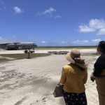 
              In this photo provided by the Australian Defence Force, the Tongan Foreign Minister, Fekitamoeloa 'Utoikamanu, right, and the Australian High Commissioner to Tonga, Rachael Moore, watch the arrival of the first Royal Australian Air Force C-17A Globemaster III aircraft at Fua'amotu International Airport near Nukuʻalofa, Tonga, Thursday, Jan. 20, 2022. The first flights carrying fresh water and other aid to Tonga were finally able to land after the Pacific nation's main airport runway was cleared of ash left by a huge volcanic eruption. (Australian Defence Force via AP)
            