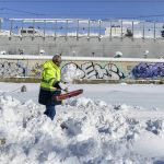 
              A worker shovel at a motorway after a snowstorm, in Athens, on Tuesday, Jan. 25, 2022. Army and fire service teams were deployed late Monday to extract hundreds of motorists trapped for hours in snowed-in cars. A snowstorm of rare severity disrupted road and air traffic Monday in the Greek capital of Athens and neighboring Turkey's largest city of Istanbul, while most of Greece, including — unusually — several Aegean islands, and much of Turkey were blanketed by snow. (AP Photo/Michael Varaklas)
            