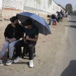 Residents wait to be tested for COVID-19 at a sports complex in the San Juan neighborhood of Lima, Peru, Tuesday, Jan. 11, 2022. Authorities in Peru are confirming a third wave of the pandemic. (AP Photo/Martin Mejia)