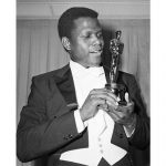
              REMOVES REFERENCE TO THE BAHAMAS - FILE - Actor Sidney Poitier poses with his Oscar for best actor for "Lillies of the Field" at the 36th Annual Academy Awards in Santa Monica, Calif. on April 13, 1964.  Poitier, the groundbreaking actor and enduring inspiration who transformed how Black people were portrayed on screen, became the first Black actor to win an Academy Award for best lead performance and the first to be a top box-office draw, died Thursday, Jan. 6, 2022. He was 94. (AP Photo, File)
            
