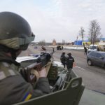
              A Ukrainian National guard soldier, left, holds his weapon ready as he guards the mobile checkpoint with the Ukrainian Security Service agents and police officers in Kharkiv, Ukraine, Thursday, Feb. 17, 2022. Fears of a new war in Europe have resurged as U.S. President Joe Biden warned that Russia could invade Ukraine within days, and violence spiked in a long-running standoff in eastern Ukraine that some fear could be the spark for wider conflict. (AP Photo/Evgeniy Maloletka)
            