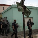 
              Riot policemen take part in an operation in the Villa Sarmiento shanty town in Buenos Aires, Argentina, Thursday, Feb. 3, 2022, where it is believed people may have purchased contaminated cocaine. A batch of cocaine that has killed at least 20 people in Argentina appears to have been laced with a synthetic opioid, and police are scrambling to get as much of it off the streets as they can. (AP Photo/Rodrigo Abd)
            