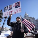 
              Denys Samokha, a native of Ukraine who now lives in Aurora, Colo., holds up placard during a protest against the invasion of the Ukraine, outside the State Capitol Saturday, Feb. 26, 2022, in Denver. (AP Photo/David Zalubowski)
            