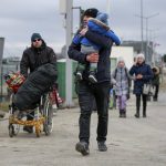 
              Refugees fleeing conflict in Ukraine arrive at the Medyka border crossing in Poland, Monday, Feb. 28, 2022. The head of the United Nations refugee agency says more than a half a million people had fled Ukraine since Russia’s invasion on Thursday. (AP Photo/Visar Kryeziu)
            