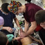 
              Medics perform CPR on a girl at the city hospital of Mariupol, who was injured during shelling in a residential area in eastern Ukraine, Sunday, Feb. 27, 2022. The girl did not survive. (AP Photo/Evgeniy Maloletka)
            