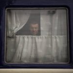 
              A man looks out of the Dnipro-Truskavets train, at the Lviv railway station, Sunday, Feb. 27, 2022, in Lviv, west Ukraine. The U.N. has estimated the conflict could produce as many as 4 million refugees. (AP Photo/Bernat Armangue)
            