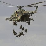 
              FILE - Soldiers abseil from a military helicopter over the training ground during strategic command and staff exercises Center-2019 at Donguz shooting range near Orenburg, Russia, Sept. 20, 2019. The main theme of the drills is the use of a coalition army group in the fight against international terrorism and providing military security in Central Asia. Servicemen from Russia, Kazakhstan, Kyrgyzstan, Tajikistan, Uzbekistan, India, China and Pakistan are taking part in the drills. Amid the soaring tensions over Ukraine, President Vladimir Putin is heading to Beijing on a trip intended to help strengthen Russia's ties with China and coordinate their policies amid Western pressure. (AP Photo/Sergei Grits, file)
            