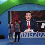 
              FILE - Chinese President Xi Jinping is seen on a screen at a booth promoting winter sports ahead of the 2022 Beijing Winter Olympics during the China International Fair for Trade in Services (CIFTIS) in Beijing, China on Sunday, Sept. 5, 2021. The Chinese president, hosting the 2022 Winter Olympics beleaguered by complaints about human rights abuses, has upended tradition to restore strongman rule in China and tighten Communist Party control over the economy and society. (AP Photo/Ng Han Guan, File)
            