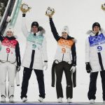 
              Nika Kriznar, of Slovenia, celebrates with teammates Timi Zajc, second from left, Ursa Bogataj, second from right, and Peter Prevc after winning gold during the ski jumping mixed team event at the 2022 Winter Olympics, Monday, Feb. 7, 2022, in Zhangjiakou, China. (AP Photo/Matthias Schrader)
            