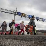 
              Refugees fleeing the conflict in Ukraine arrive at the Medyka border crossing in Poland, Monday, Feb. 28, 2022. The U.N. has estimated the conflict could produce as many as 4 million refugees. (AP Photo/Visar Kryeziu)
            