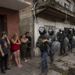 
              Riot policemen take part in an operation in the Villa Sarmiento shanty town in Buenos Aires, Argentina, Thursday, Feb. 3, 2022, where it is believed people may have purchased contaminated cocaine. A batch of cocaine that has killed at least 20 people in Argentina appears to have been laced with a synthetic opioid, and police are scrambling to get as much of it off the streets as they can. (AP Photo/Rodrigo Abd)
            