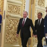 FILE - Russian President Vladimir Putin and Foreign Minister Sergei Lavrov walk past honour guards as they attend a ceremony to receive diplomatic credentials from newly appointed foreign ambassadors at the Kremlin in Moscow, Russia, Thursday, Oct. 11, 2018. In the wake of the 2022 invasion of Ukraine, U.S. sanctions are targeting Putin and a handful of individuals believed to be among his closest security advisers, including Lavrov. (Sergei Karpukhin/Pool Photo via AP, File)
