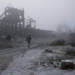 
              FILE - In this Nov. 19, 2019 file photo, a Ukrainian soldier passes by a destroyed Butovka coal mine as he approaches his front line position in the town of Avdiivka in the Donetsk region, Ukraine. It is Ukraine, not Russia, where the economy is eroding the fastest under the threat of war. Even before Russia launched its latest invasion, costing 70 years of hard-won European peace, Ukraine was the biggest loser in the agonizing, slow-motion aggression. (AP Photo/Vitali Komar, File)
            