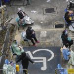 
              People, including current hospital patients, showing COVID-19 symptoms wait at a temporary holding area outside Caritas Medical Centre in Hong Kong Wednesday, Feb. 16, 2022. China's leader Xi Jinping took a personal interest in Hong Kong's outbreak, saying it was the local government's "overriding task" to control the situation, a Hong Kong newspaper said on Wednesday. (AP Photo Vincent Yu)
            