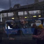 
              Refugees from Ukraine wait in a heated bus after arriving at Nyugati station in Budapest, Hungary, on Monday, Feb. 28, 2022. Explosions and gunfire that have disrupted life since the invasion began last week appeared to subside around Kyiv overnight, as Ukrainian and Russian delegations met Monday on Ukraine's border with Belarus. (AP Photo/Anna Szilagyi)
            