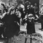 
              FILE- In this April 19, 1943 file photo, a group of Jews are escorted from the Warsaw Ghetto by German soldiers. (AP Photo/File)
            