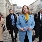 
              FILE - Acting United States ambassador Kristina Kvien, center, walks in Lviv, Ukraine, Tuesday, Feb. 15, 2022. The United States relocated the embassy from Kyiv to the western Ukrainian city of Lviv, citing a "dramatic acceleration" in the buildup of Russian forces at the country's border. One by one, embassies and international offices in Kyiv closed. Flight after flight was canceled when insurance companies balked at covering planes arriving in Ukraine. Hundreds of millions of dollars in investment dried up within weeks. (AP Photo/Mykola Tys, File)
            
