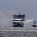 
              Smoke rises from the Italian-flagged Euroferry Olympia, which is on fire for third day, in the Ionian sea near the Greek island of Corfu, on Sunday, Feb. 20, 2022. After working all night to try to extinguish the blaze that broke out Friday, firefighting vessels surrounded the Euroferry Olympia, which was carrying more than 290 passengers and crew. The Greek coast guard and other boats evacuated about 280 of them to Corfu. (AP Photo/Petros Giannakouris)
            