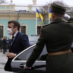 
              French President Emmanuel Macron arrives to meet Ukrainian President Volodymyr Zelenskyy Tuesday, Feb. 8, 2022 in Kyiv, Ukraine. Diplomatic efforts to defuse the tensions around Ukraine continued on Tuesday with French President Emmanuel Macron in Kyiv the day after hours of talks with the Russian leader in Moscow yielded no apparent breakthroughs. (AP Photo/Thibault Camus, Pool)
            