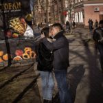 
              A couple kisses on a street in downtown Kiev, Ukraine, Monday, Feb. 14, 2022. More NATO troops headed to Eastern Europe and some nations worked to move their citizens and diplomats out of Ukraine on Monday, as Germany's chancellor made a last-ditch attempt to head off a feared Russian invasion that some warn could be just days away. (AP Photo/Emilio Morenatti)
            
