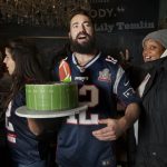 
              In a photo provided by Marisha Camp, Meir Kay, founder of Super Soul Party, holds a cake at a Super Bowl party organized by his nonprofit organization for homeless people, Feb. 3, 2019, in New York. Super Soul Party, a nonprofit started by filmmaker and social media influencer Meir Kay, will have Super Bowl parties in 35 cities when the Cincinnati Bengals and Los Angeles Rams meet Feb. 13. (Marisha Camp via AP)
            
