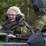 
              German Defence Minister Christine Lambrecht, left, rides in a tank during her visit to the Tank Training Brigade 9 in Munster, Germany, Monday, Feb. 7, 2022. Germany says it will add up to 350 troops to a NATO battlegroup it leads in Lithuania, an announcement that comes amid tensions between Russia and Ukraine and criticism of Berlin's refusal to send weapons to Kyiv. Defense Minister Christine Lambrecht said during a trip to troops in northern Germany on Monday that the extra soldiers will be dispatched 'within a few days'. (Philipp Schulze/dpa via AP)
            
