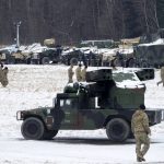 
              US soldiers walk at a local airport in Arlamow, southeastern Poland, near the border with Ukraine, on Monday, Feb. 28, 2022. President Vladimir Putin dramatically escalated East-West tensions by ordering Russian nuclear forces put on high alert following new crippling Western sanctions that forced his Central Bank to sharply raise its key rate Monday to save the ruble from collapse. (AP Photo/Czarek Sokolowski)
            