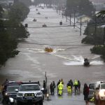 
              People use small boats to travel through flood water in Lismore, Australia, Monday, Feb. 28, 2022. Heavy rain is bringing record flooding to some east coast areas and claimed seven lives while the flooding in Brisbane, a population of 2.6 million, and its surrounds is the worst since 2011 when the city was inundated by what was described as a once-in-a-century event. (Jason O'Brien/AAP Image via AP)
            