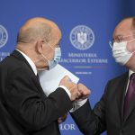 
              France's European and Foreign Affairs Minister Jean-Yves Le Drian touches fists with Romanian counterpart Bogdan Aurescu, right, after a joint press conference in Bucharest, Romania, Thursday, Feb.3, 2022. (AP Photo/Andreea Alexandru)
            
