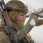 
              A Ukrainian serviceman holds his weapin at a frontline position in the Luhansk region, eastern Ukraine, Monday, Feb. 7, 2022. International efforts to defuse the standoff over Ukraine intensified Monday, with French President Emmanuel Macron holding talks in Moscow and German Chancellor Olaf Scholz in Washington to coordinate policies as fears of a Russian invasion mounted.(AP Photo/Vadim Ghirda)
            