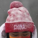 
              A member of the team China is covered by the snow as the start of the women's slopestyle qualification has been postponed due to a weather consition at the 2022 Winter Olympics, Sunday, Feb. 13, 2022, in Zhangjiakou, China. (AP Photo/Francisco Seco)
            
