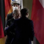 
              German Chancellor Olaf Scholz, front left, welcomes French President Emmanuel Macron, right, for a meeting at the Chancellery in Berlin, Germany, Tuesday, Feb. 8, 2022. (AP Photo/Michael Sohn)
            