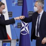 
              NATO Secretary General Jens Stoltenberg, right, and Poland's President Andrej Duda fist bump after participating in a joint media conference at NATO headquarters in Brussels, Monday, Feb. 7, 2022. (AP Photo/Olivier Matthys)
            