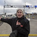 
              Hanna Pavlovna Lukasz, from Mirhord, Ukraine, shouts and reacts after her 12 and 8-year-old sons and her 66-year-old mother have been waiting on the Ukrainian side of the border for four days to cross at the Medyka border crossing in Poland, Monday, Feb. 28, 2022. The head of the United Nations refugee agency says more than a half a million people had fled Ukraine since Russia’s invasion on Thursday. (AP Photo/Visar Kryeziu)
            