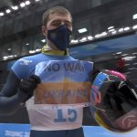 
              In this frame from video, Vladyslav Heraskevych, of Ukraine, holds a sign that reads "No War in Ukraine" after finishing a run at the men's skeleton competition at the 2022 Winter Olympics, Friday, Feb. 11, 2022, in the Yanqing district of Beijing. (NBC via AP)
            