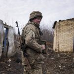 
              A Ukrainian serviceman stands at his position at the line of separation between Ukraine-held territory and rebel-held territory near Svitlodarsk, eastern Ukraine, Wednesday, Feb. 23, 2022. U.S. President Joe Biden announced the U.S. was ordering heavy financial sanctions against Russia, declaring that Moscow had flagrantly violated international law in what he called the "beginning of a Russian invasion of Ukraine." (AP Photo/Evgeniy Maloletka)
            